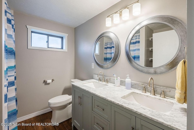 102295 US Highway 89, Thayne, WY 83127 - bathroom with wood finished floors, baseboards, toilet, and double vanity