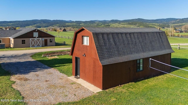 102295 US Highway 89, Thayne, WY 83127 - view of barn with a mountain view and driveway