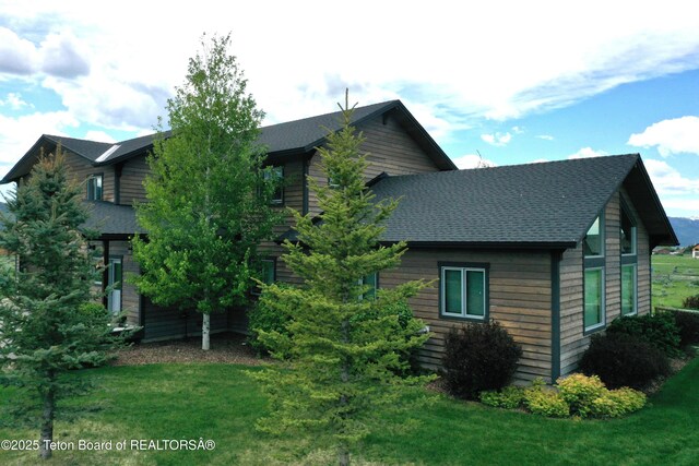 9075 Nesting Eagles Loop, Victor, ID 83455 - rear view of property with a lawn and a shingled roof