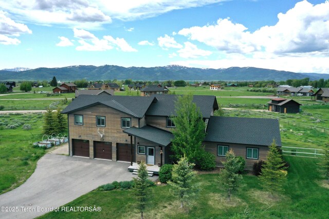 9075 Nesting Eagles Loop, Victor, ID 83455 - chalet / cabin featuring a mountain view, an attached garage, and asphalt driveway