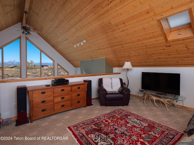 living area featuring lofted ceiling, a ceiling fan, light carpet, baseboards, and wood ceiling