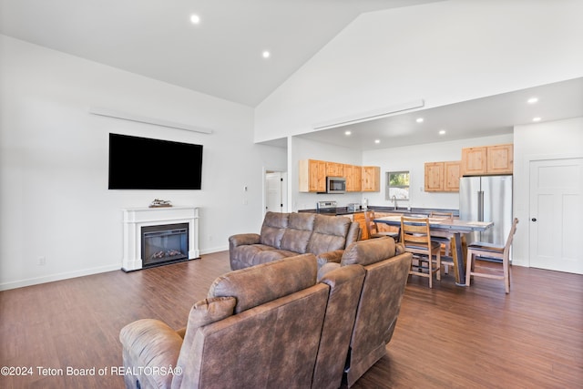 604 Falcon Dr, Alpine, WY 83128 - living room featuring high vaulted ceiling, dark wood finished floors, a glass covered fireplace, and recessed lighting