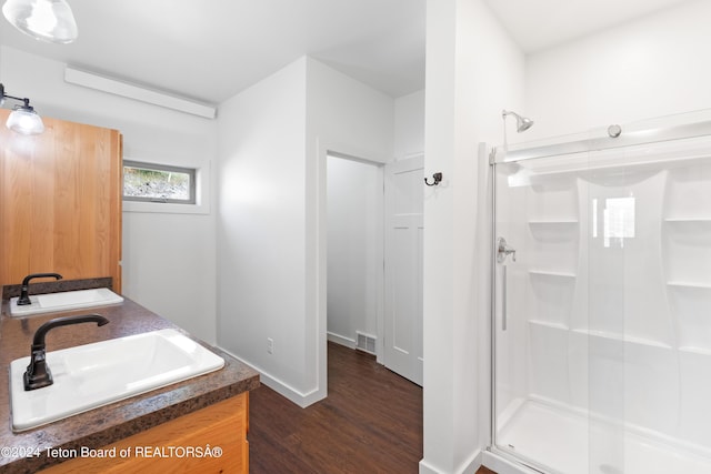 604 Falcon Dr, Alpine, WY 83128 - bathroom with a shower stall, visible vents, wood finished floors, and a sink