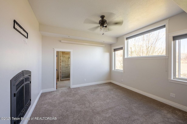 unfurnished bedroom featuring carpet flooring, heating unit, multiple windows, and baseboards