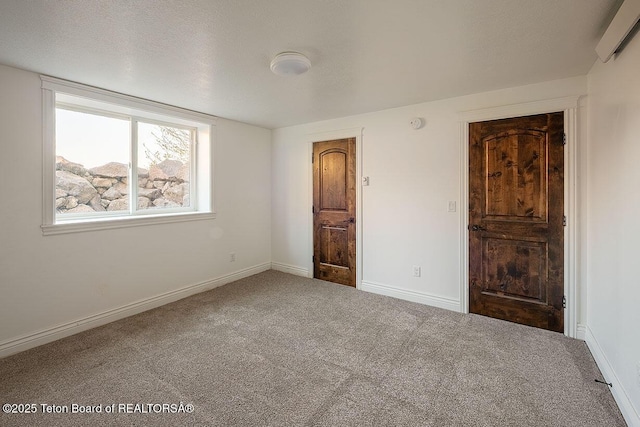 unfurnished bedroom with carpet flooring and baseboards