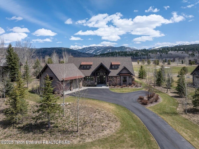 37 Rammell Rd, Victor, ID 83455 - view of front of house with stone siding, curved driveway, and a mountain view