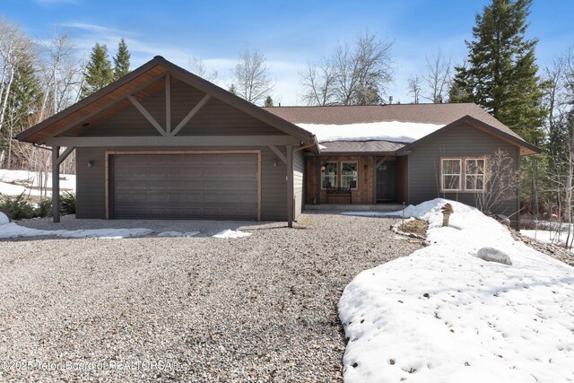 332 N Forest Dr, Star Valley Ranch, WY 83127 - view of front of property with an attached garage, gravel driveway, and roof with shingles