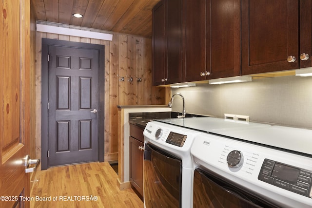 332 N Forest Dr, Star Valley Ranch, WY 83127 - laundry area with wooden ceiling, washing machine and dryer, light wood-type flooring, cabinet space, and wooden walls