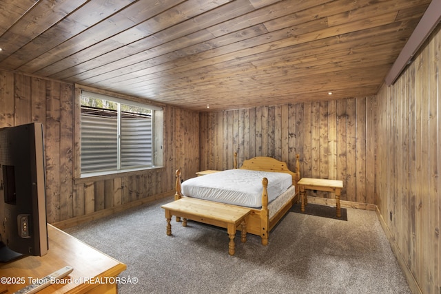 332 N Forest Dr, Star Valley Ranch, WY 83127 - bedroom with wooden walls, baseboards, carpet flooring, and wooden ceiling