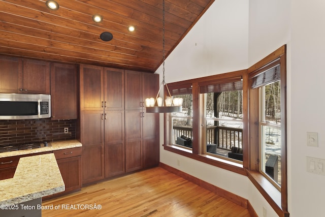 332 N Forest Dr, Star Valley Ranch, WY 83127 - kitchen with stainless steel appliances, recessed lighting, lofted ceiling, decorative backsplash, and wooden ceiling