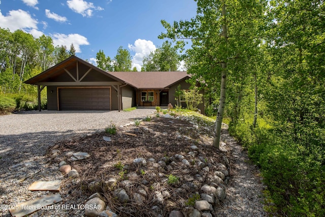 332 N Forest Dr, Star Valley Ranch, WY 83127 - view of front of home featuring a garage and gravel driveway