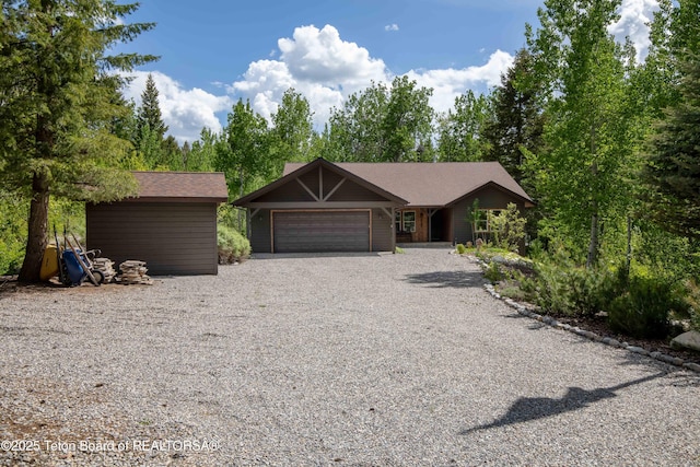332 N Forest Dr, Star Valley Ranch, WY 83127 - view of front of property featuring an attached garage and gravel driveway