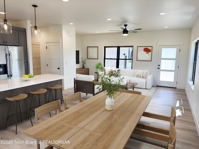 668 Palisade Trl, Driggs, ID 83422 - dining area with light wood finished floors, a ceiling fan, and recessed lighting