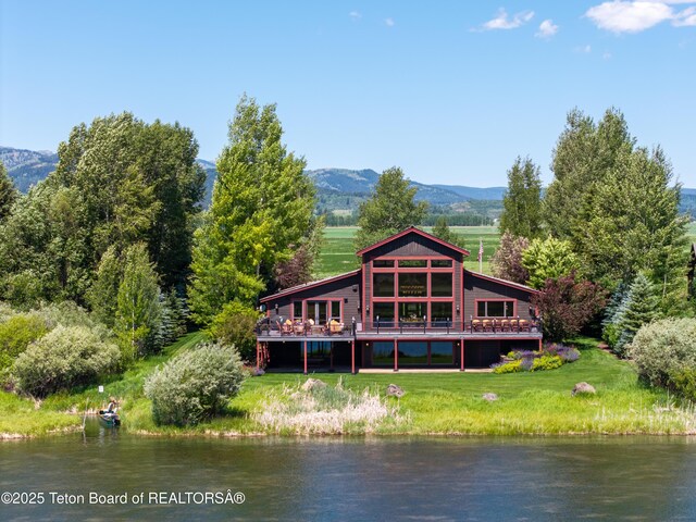 4053 S Adams Rd, Driggs, ID 83422 - rear view of house featuring a lawn and a deck with water view