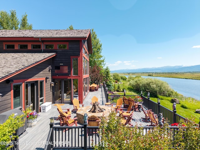 4053 S Adams Rd, Driggs, ID 83422 - deck with a fire pit and a water and mountain view