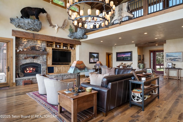 4053 S Adams Rd, Driggs, ID 83422 - living area with wood finished floors, a high ceiling, a fireplace, a chandelier, and recessed lighting