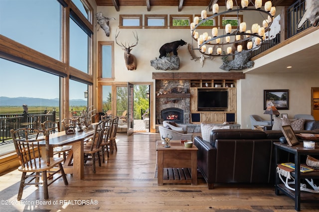 4053 S Adams Rd, Driggs, ID 83422 - living area featuring a mountain view, a high ceiling, hardwood / wood-style flooring, beamed ceiling, and a chandelier