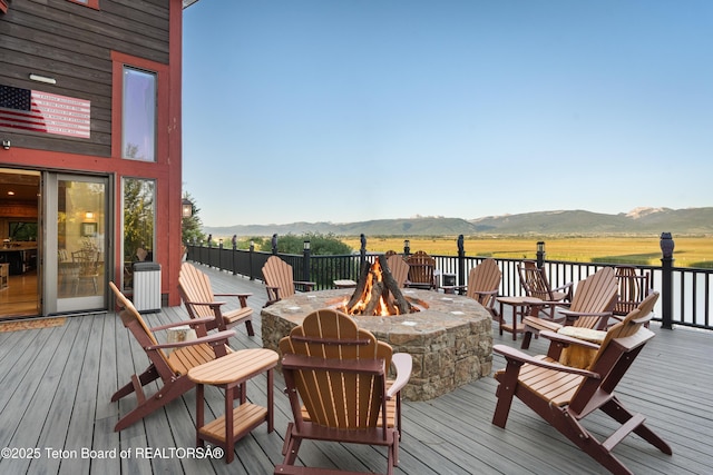 4053 S Adams Rd, Driggs, ID 83422 - wooden terrace with an outdoor fire pit and a mountain view