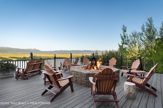 4053 S Adams Rd, Driggs, ID 83422 - wooden deck featuring an outdoor fire pit and a mountain view