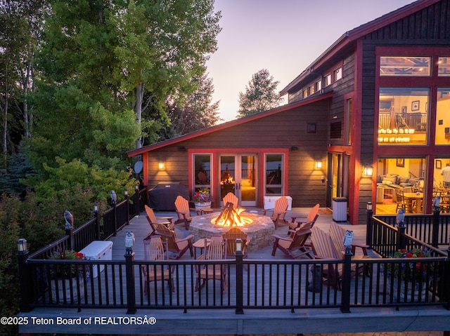 4053 S Adams Rd, Driggs, ID 83422 - deck at dusk featuring a fire pit and a patio