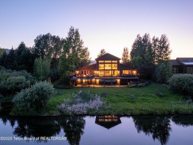 4053 S Adams Rd, Driggs, ID 83422 - back of house at dusk with a water view and a yard