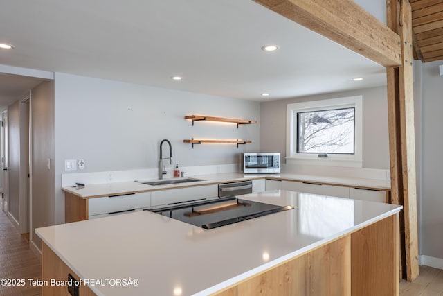 1710 E Porcupine Rd, Jackson, WY 83001 - kitchen with a sink, stainless steel appliances, modern cabinets, white cabinets, and recessed lighting