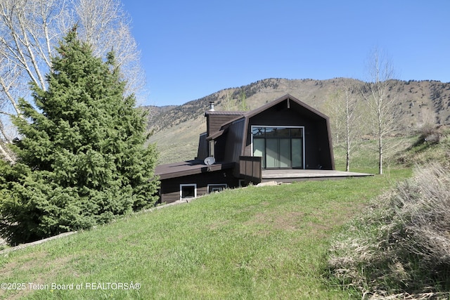 1710 E Porcupine Rd, Jackson, WY 83001 - rear view of property featuring a chimney, a mountain view, and a yard