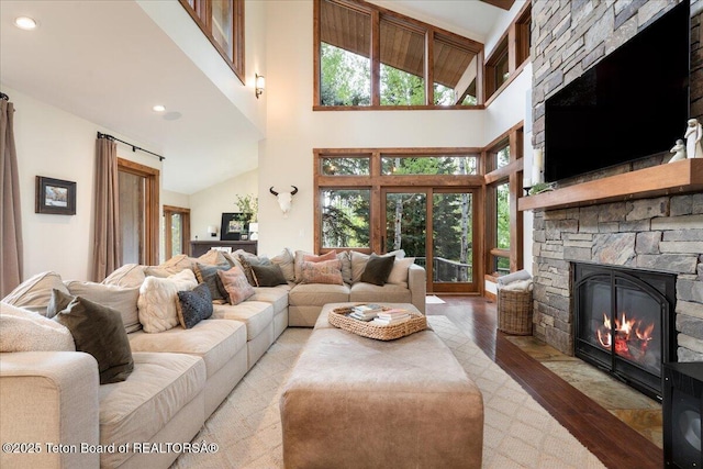 3375 W Killdeer Rd, Jackson, WY 83001 - living room with hardwood / wood-style flooring, a stone fireplace, high vaulted ceiling, and recessed lighting