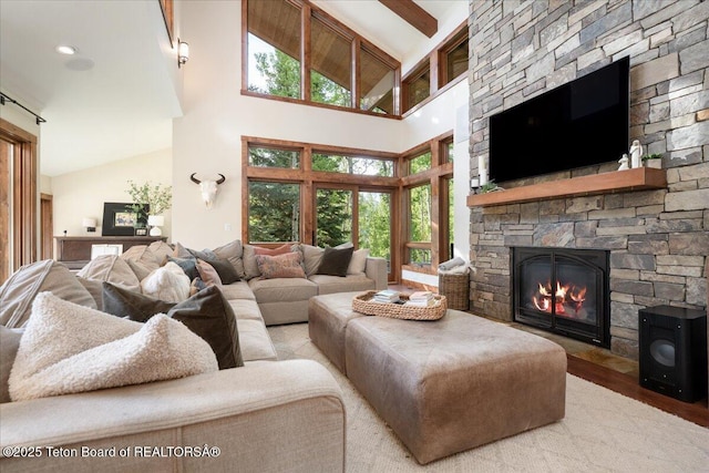 3375 W Killdeer Rd, Jackson, WY 83001 - living room featuring high vaulted ceiling, wood finished floors, a fireplace, and beamed ceiling