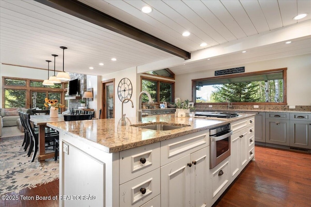 3375 W Killdeer Rd, Jackson, WY 83001 - kitchen featuring a sink, appliances with stainless steel finishes, recessed lighting, an island with sink, and light stone countertops