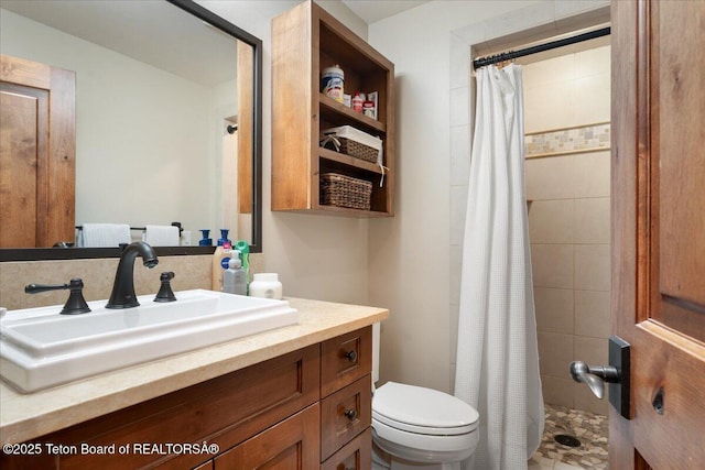 3375 W Killdeer Rd, Jackson, WY 83001 - bathroom featuring vanity, tiled shower, and toilet