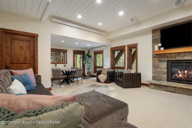 3375 W Killdeer Rd, Jackson, WY 83001 - carpeted living room featuring recessed lighting, wooden ceiling with exposed beams, a stone fireplace, and baseboards