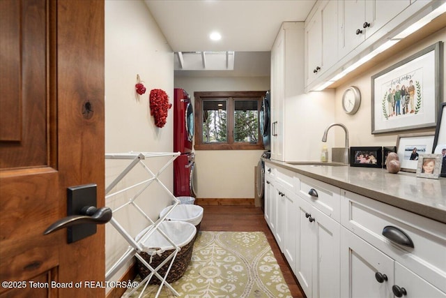 3375 W Killdeer Rd, Jackson, WY 83001 - kitchen featuring a sink, white cabinetry, dark wood-style floors, washer / clothes dryer, and recessed lighting