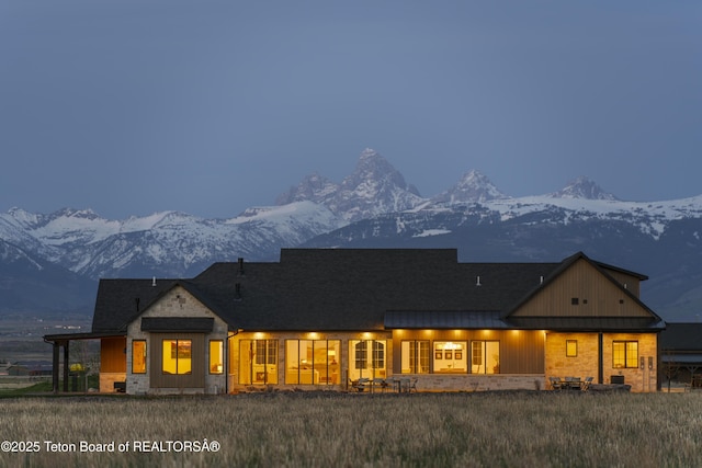 1070 Horseshoe Ln, Driggs, ID 83422 - view of front of house featuring a mountain view, a standing seam roof, board and batten siding, metal roof, and stone siding