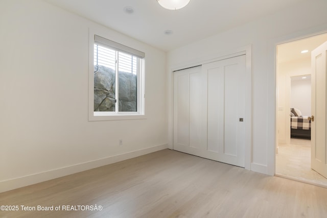 1070 Horseshoe Ln, Driggs, ID 83422 - unfurnished bedroom featuring light wood-type flooring, baseboards, and a closet