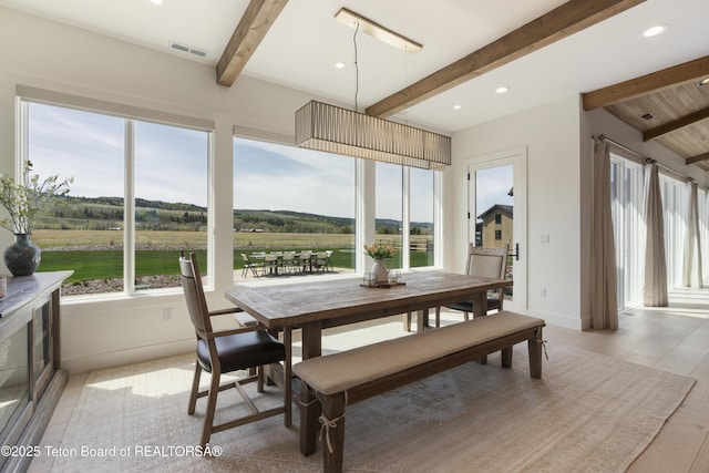1070 Horseshoe Ln, Driggs, ID 83422 - dining space with beamed ceiling, recessed lighting, baseboards, light wood-type flooring, and a view of countryside