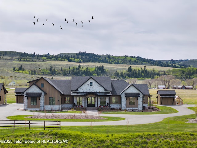 1070 Horseshoe Ln, Driggs, ID 83422 - view of front of house featuring stone siding, a garage, and board and batten siding