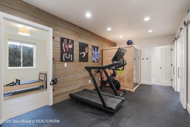 1070 Horseshoe Ln, Driggs, ID 83422 - workout room with a barn door, recessed lighting, wood walls, and baseboards