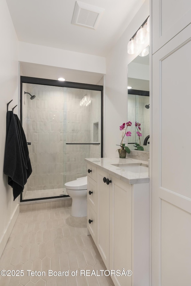 1070 Horseshoe Ln, Driggs, ID 83422 - full bathroom with a stall shower, vanity, toilet, and tile patterned floors