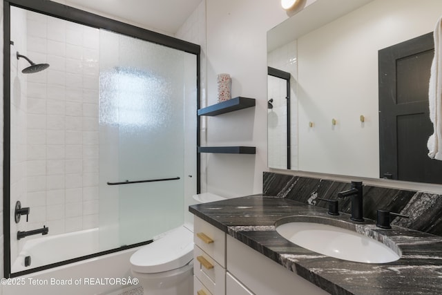 1070 Horseshoe Ln, Driggs, ID 83422 - full bath featuring toilet, shower / bath combination with glass door, vanity, and backsplash