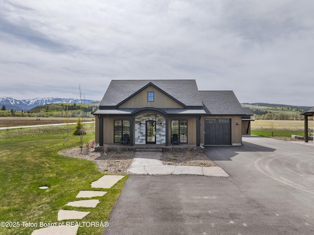 1070 Horseshoe Ln, Driggs, ID 83422 - view of front of property featuring a mountain view, a front yard, and covered porch