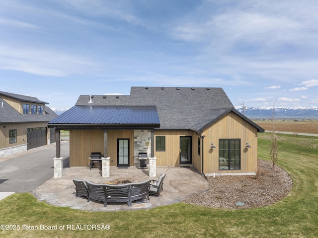 1070 Horseshoe Ln, Driggs, ID 83422 - back of house featuring a patio, a yard, and metal roof
