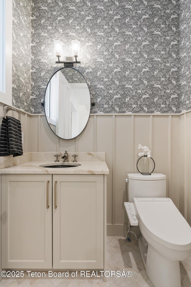 1070 Horseshoe Ln, Driggs, ID 83422 - bathroom featuring a decorative wall, toilet, vanity, and marble finish flooring