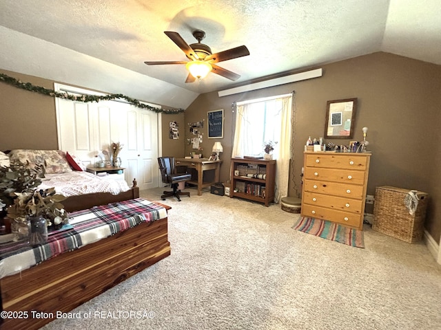 125 Wagon Rut Ln, Auburn, WY 83111 - carpeted bedroom featuring vaulted ceiling, a desk, a textured ceiling, and a ceiling fan