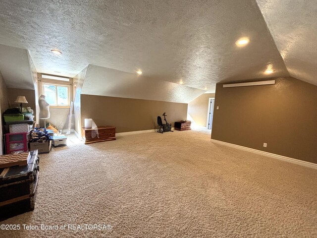 125 Wagon Rut Ln, Auburn, WY 83111 - bonus room with a textured ceiling, carpet, lofted ceiling, and baseboards