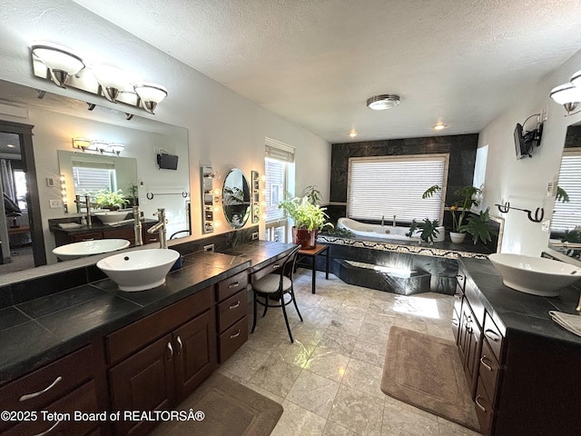 125 Wagon Rut Ln, Auburn, WY 83111 - full bathroom with a garden tub, vanity, and a textured ceiling