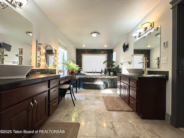 125 Wagon Rut Ln, Auburn, WY 83111 - bathroom with a garden tub, two vanities, and a textured ceiling