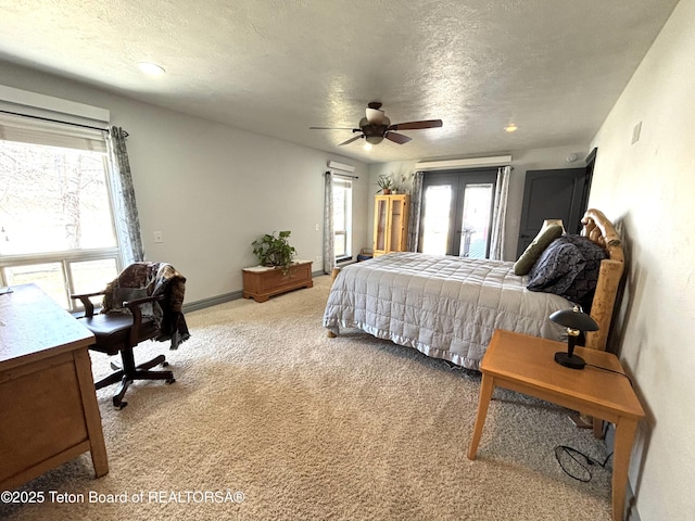 125 Wagon Rut Ln, Auburn, WY 83111 - bedroom featuring light colored carpet, multiple windows, a textured ceiling, access to outside, and ceiling fan