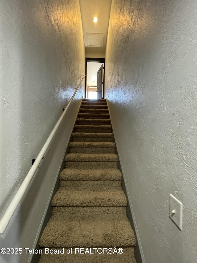 125 Wagon Rut Ln, Auburn, WY 83111 - staircase featuring baseboards, carpet flooring, and a textured wall