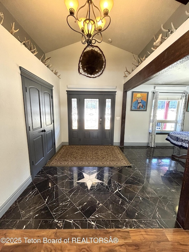 125 Wagon Rut Ln, Auburn, WY 83111 - entryway with baseboards, marble tiled floors, a chandelier, and high vaulted ceiling